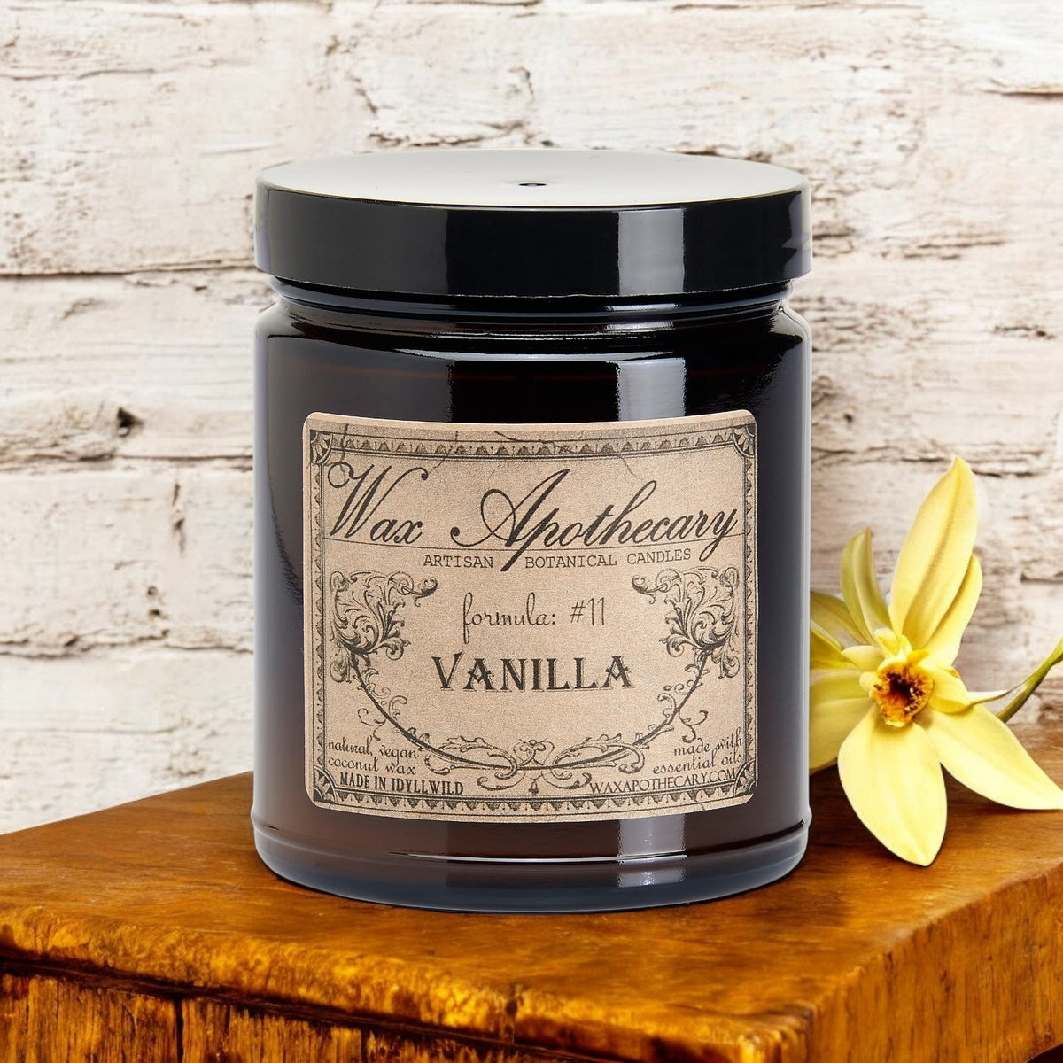 Vanilla botanical candle in an amber glass jar by Wax Apothecary